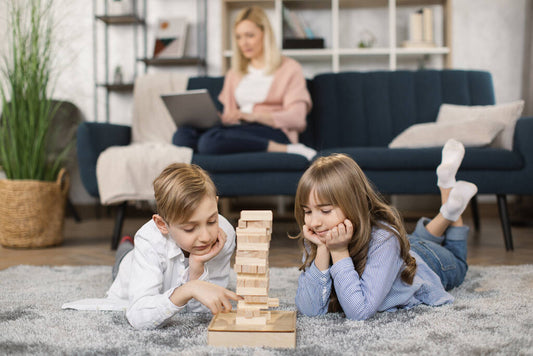 children sit on warm floor in living room